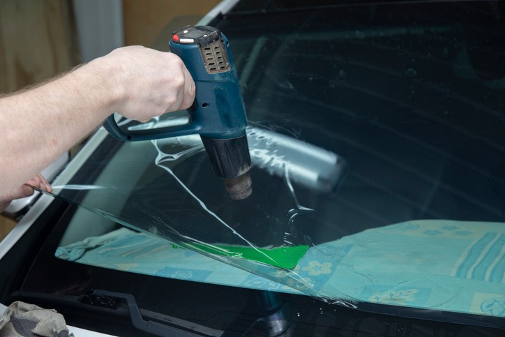 Expert sealing a car windshield to prevent leaks in Edmonton & Leduc